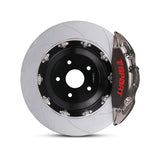 Close-up of a chrome TTSPORT DRT4+2 6-piston forged brake caliper for the rear wheel and a slotted 2-piece floating rotor.