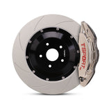 Close-up of a chrome TTSPORT DRT6 6-piston forged brake caliper for the front wheel and a slotted 2-piece rotor.