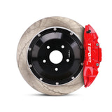 Close-up of a red TTSPORT EP4S 4-piston forged brake caliper with EPB motor for the rear wheel and a slotted 2-piece floating rotor.