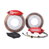 Complete TTSPORT Suzuki Jimny front wheel big brake kit, showing the 4-piston forged calipers, slotted rotor, performance pads, and steel-braided brake lines.