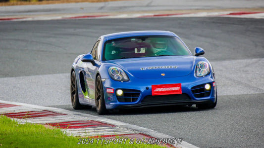 TTSPORT-equipped Porsche 718 race car charging through a corner at the GIC Super Track Festival