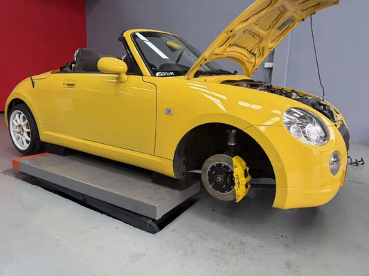 Daihatsu Copen fitted with TTSPORT SL6S six-piston big brake kit behind its stock 15-inch wheel
