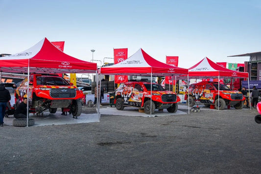 Chery Tiggo 8 factory rally car racing through desert terrain at the 2026 China Silk Road Rally