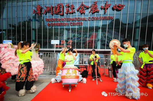 Lion dance performers open Foshan GT Show South China amid drums and confetti on the show floor