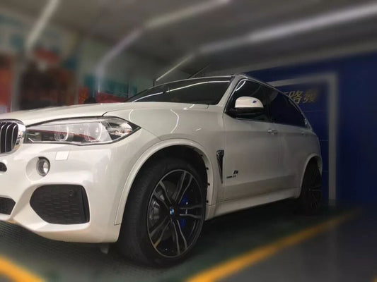 BMW X5 fitted with TTSPORT Racing big brake kit behind stock 21-inch wheels, front and rear