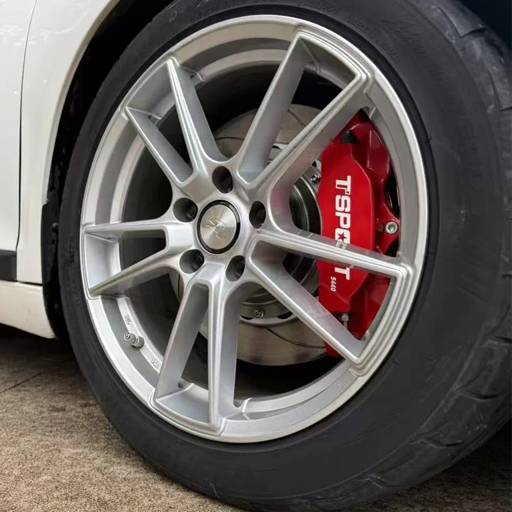 A red TTSPORT 5440 4-piston big brake kit is installed on the 15" front wheel.