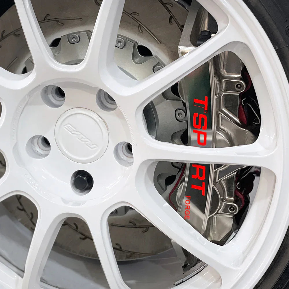 A red TTSPORT EMB6 monoblock 6-piston big brake kit is installed on the 18" front wheel.