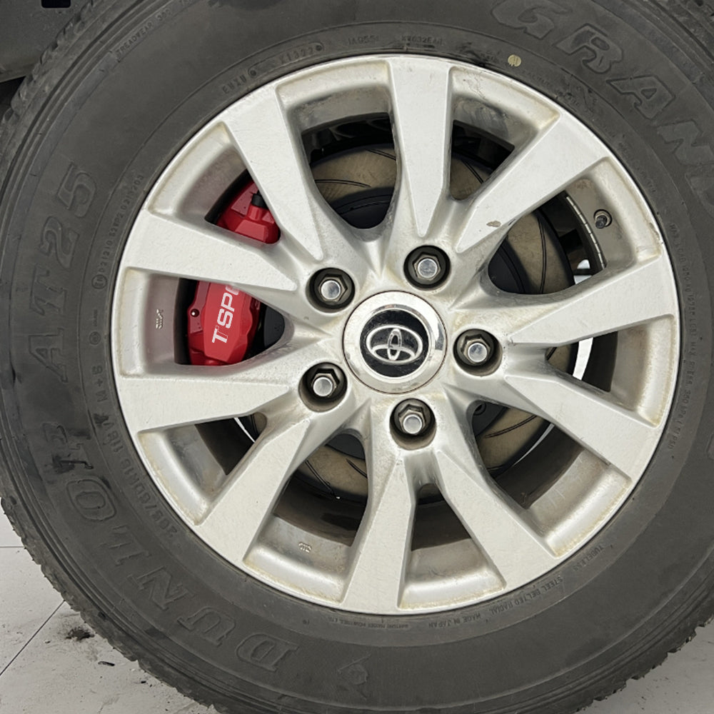 A red TTSPORT Toyota Land Cruiser and Prado 4-piston big brake kit is installed on the rear wheel.